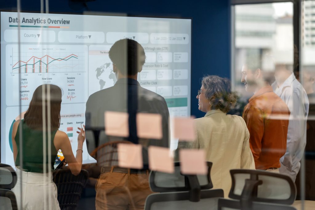 A group of business people analysing a dashboard